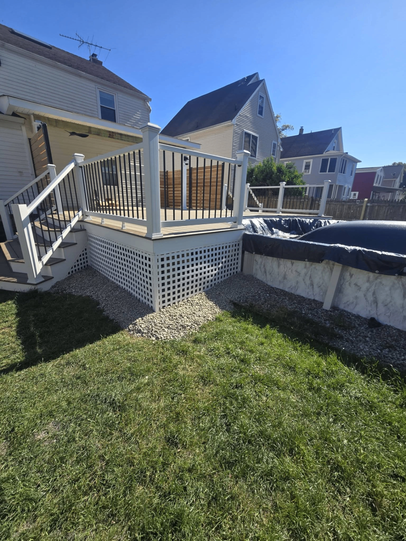 Two-tone deck overlooking a backyard pool