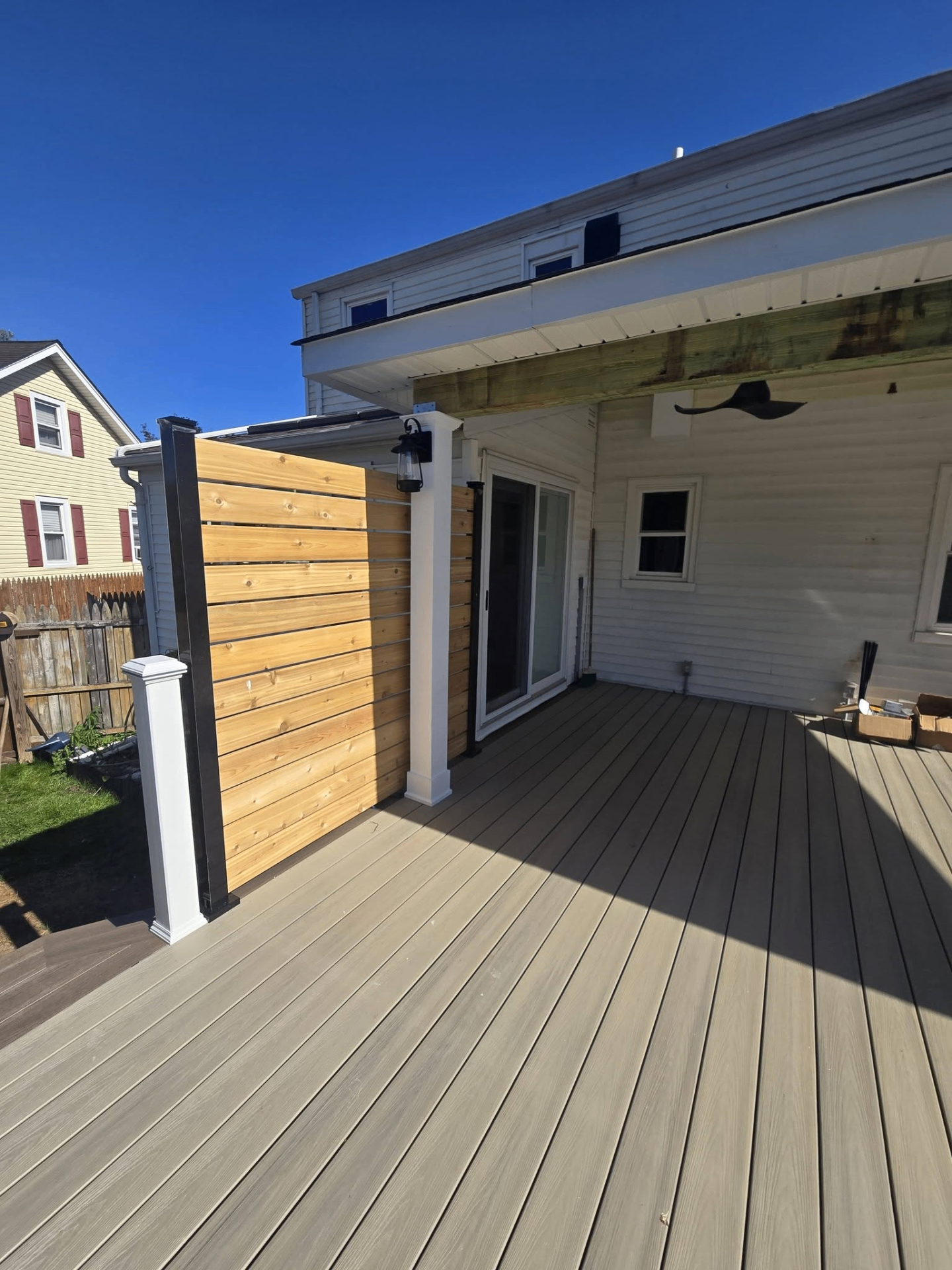 Composite deck with cedar privacy wall and lantern