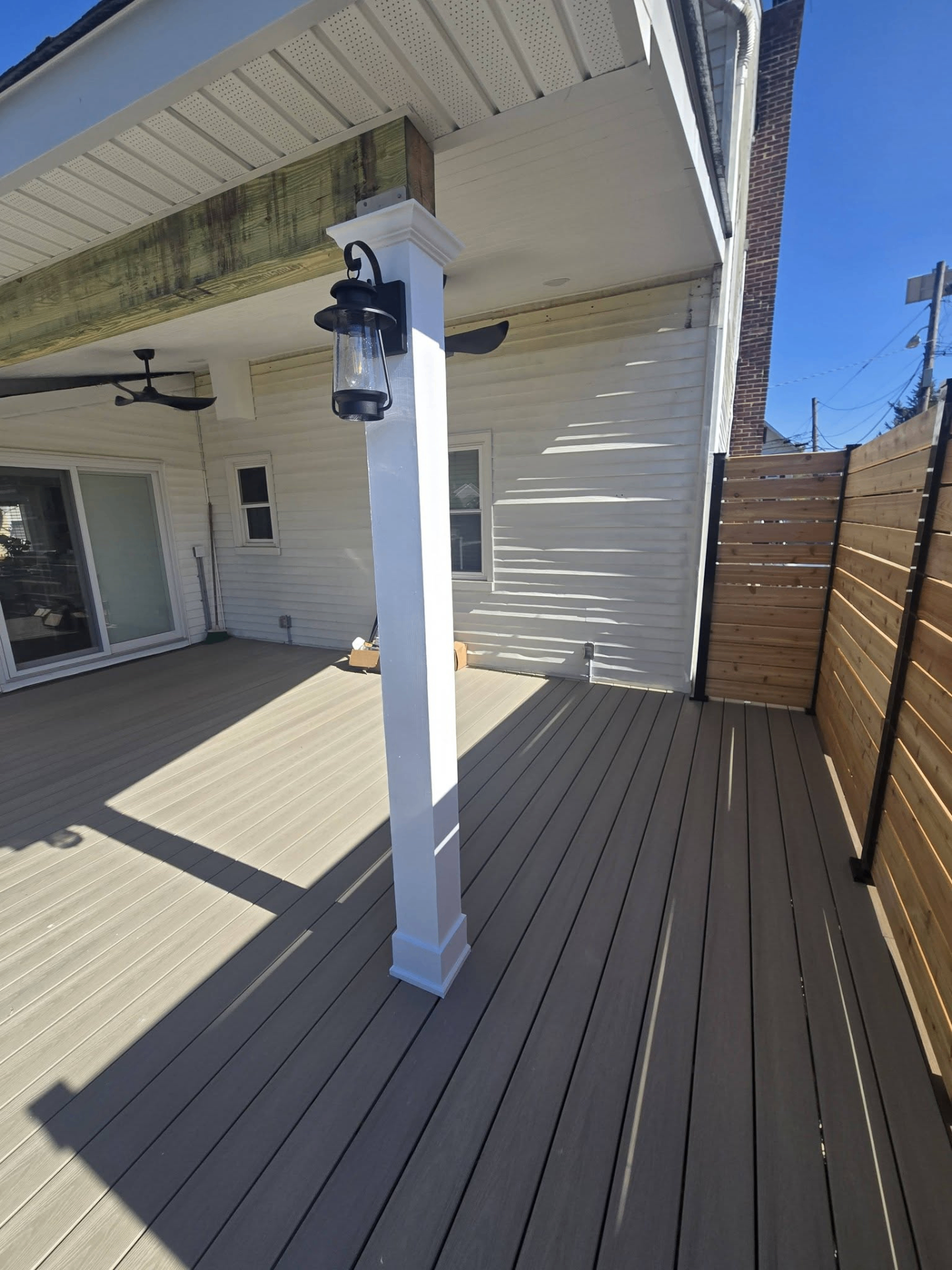 Two-tone composite deck with cedar privacy fence